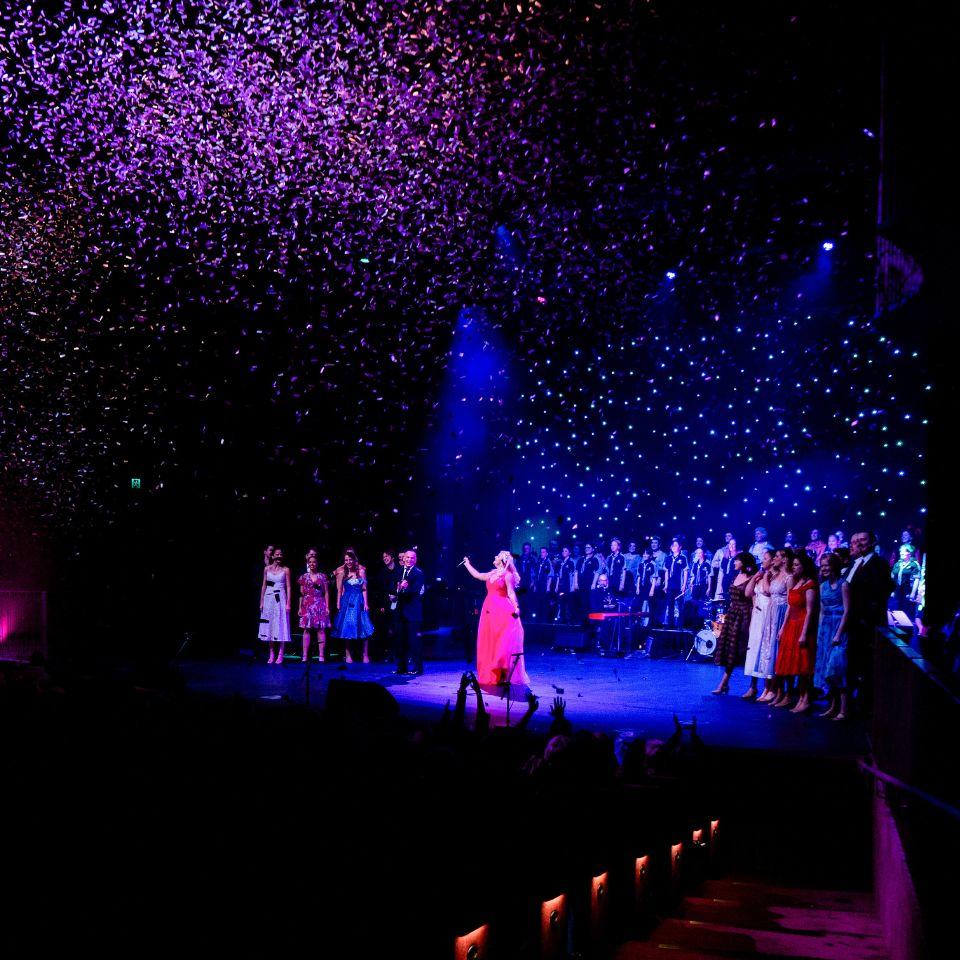 Lucy Durack on-stage as confetti fires over the crowd at The Round's Opening Night.