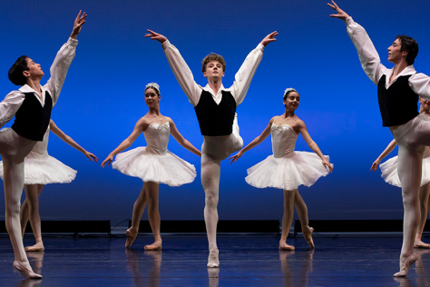 Some fun ballerinas are doing ballet, they look a bit like swans. 